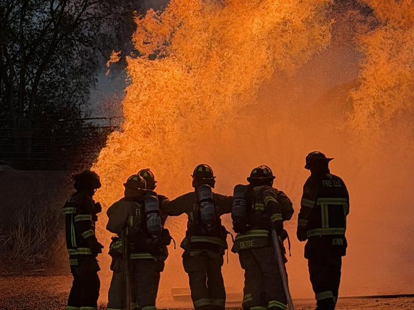 Baraboo Area Fire and EMS District firefighters advancing together during live-fire training.