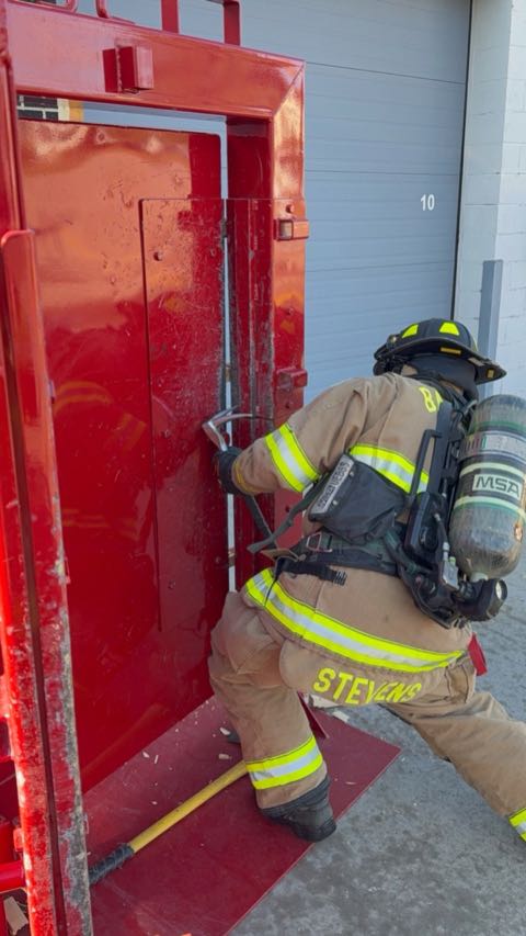A Baraboo firefighter practices forcible entry on the Association-funded training door.