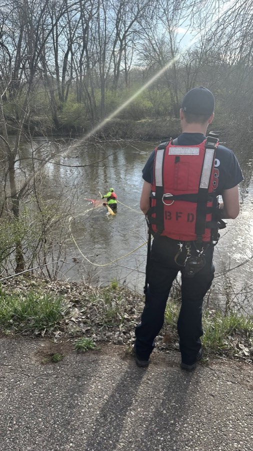 Baraboo Area Fire and EMS District personnel conducting tethered swift-water rescue training in a wooded waterway.